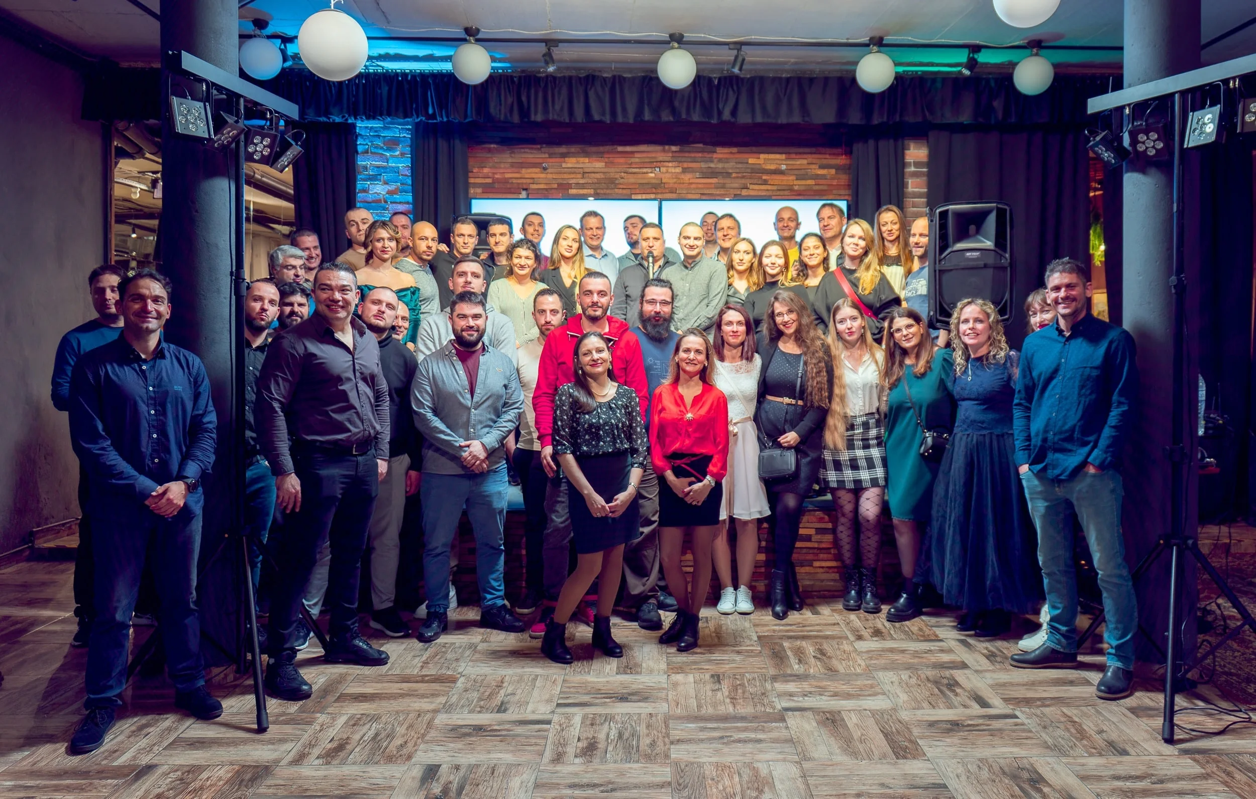 Group photo of the Comstream team standing together in an indoor setting