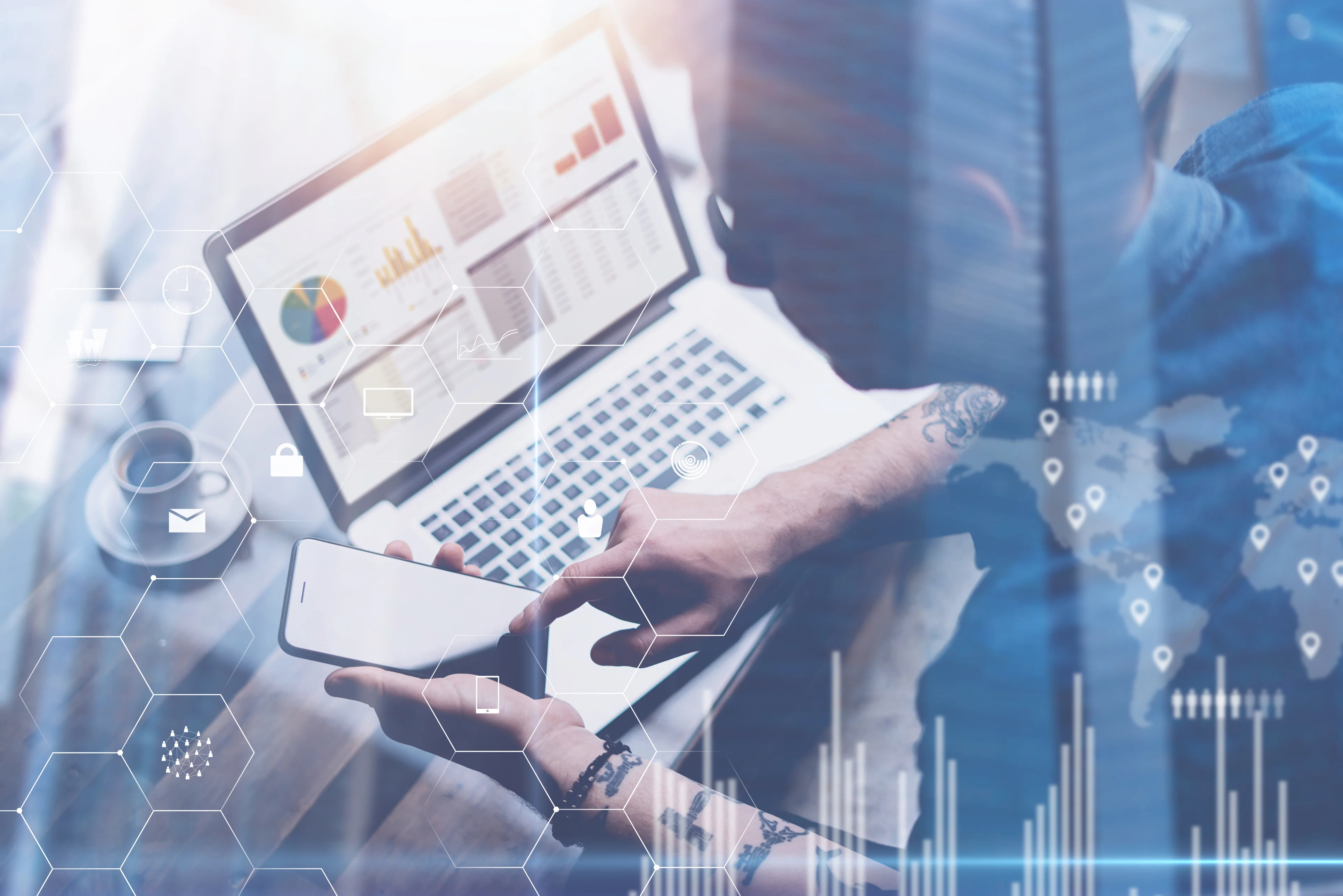 Person using a smartphone and laptop to access analytics, representing account registration and digital hiring tools